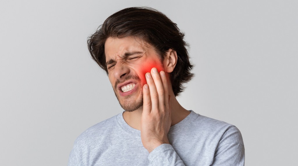 A man experiencing dental pain